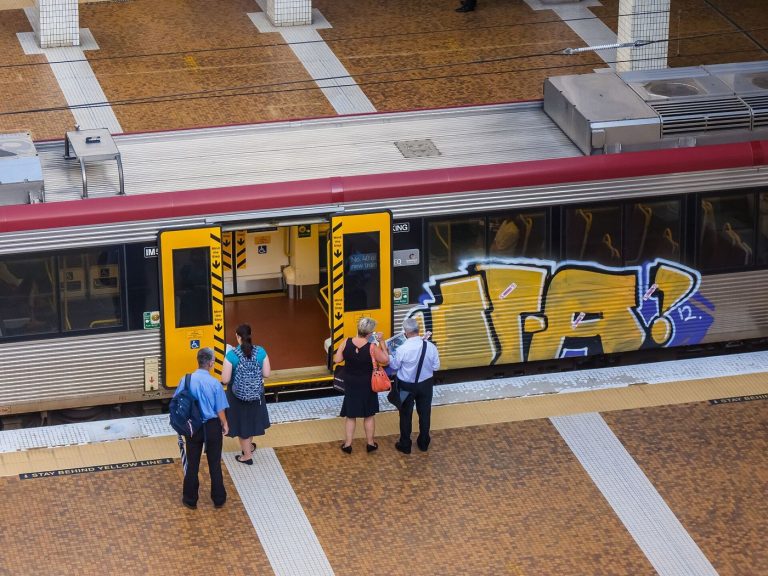 Commuters waiting on a busy train station platform