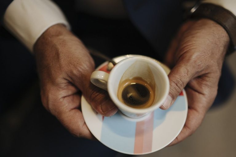A small cup of dark espresso on a cafe table